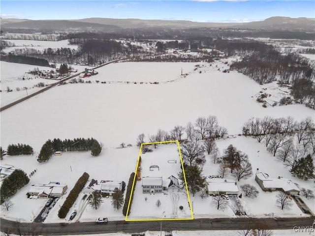 snowy aerial view featuring a mountain view