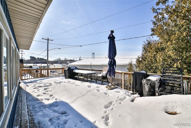 snowy yard with a wooden deck