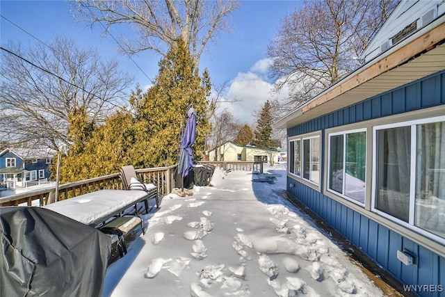 snow covered deck featuring grilling area