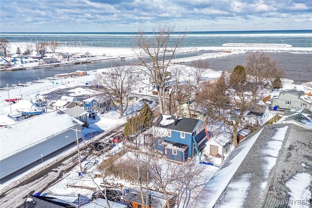 snowy aerial view featuring a water view