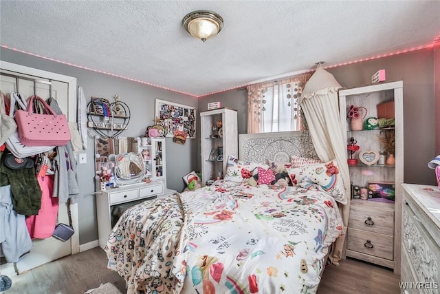 bedroom with hardwood / wood-style floors and a textured ceiling