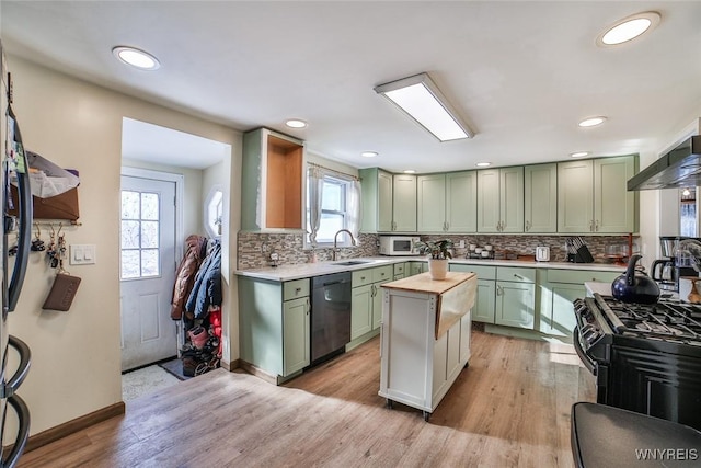 kitchen featuring a wealth of natural light, dishwasher, green cabinets, and black gas range oven