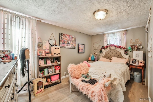 bedroom featuring a textured ceiling and light wood-type flooring