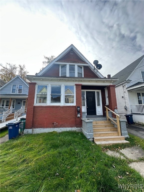 bungalow-style home featuring a front yard