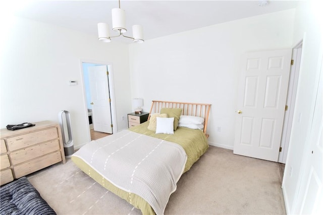 bedroom with light carpet and a chandelier