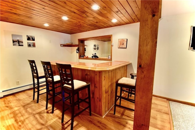 bar featuring light hardwood / wood-style flooring, wooden ceiling, and baseboard heating