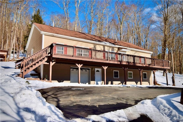 view of front of house with a garage and a deck