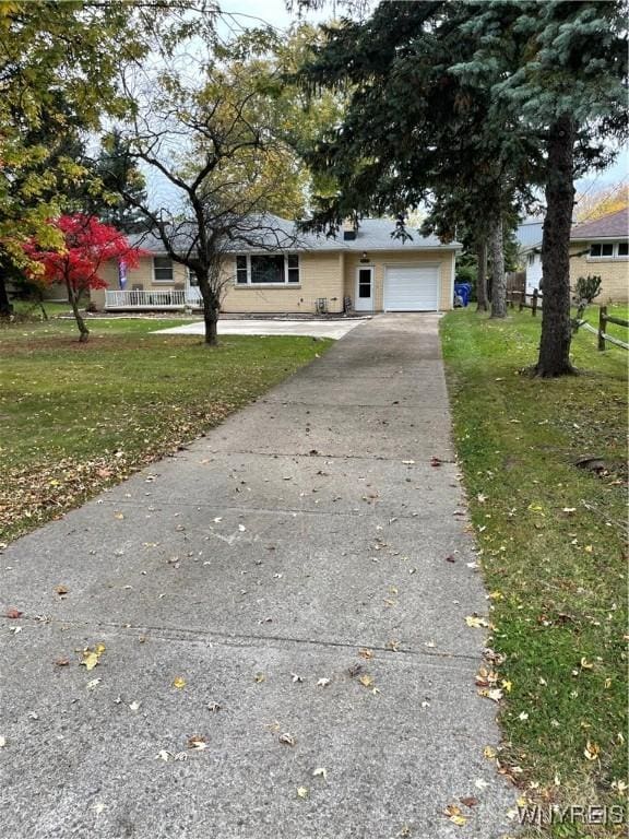 view of front facade with a garage and a front lawn