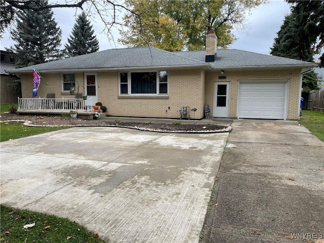 ranch-style house with a garage and covered porch