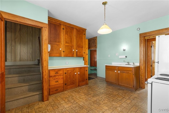 1407 Downer Ave, Utica, NY 13502 - kitchen with white appliances, pendant lighting, light countertops, and brown cabinetry