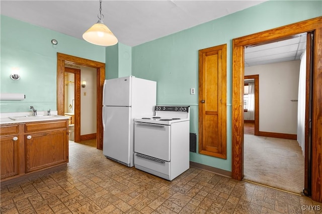 1407 Downer Ave, Utica, NY 13502 - kitchen with white appliances, light countertops, brown cabinetry, and pendant lighting