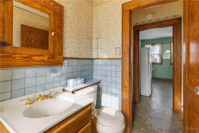 1407 Downer Ave, Utica, NY 13502 - bathroom with vanity, wallpapered walls, a wainscoted wall, and tile walls