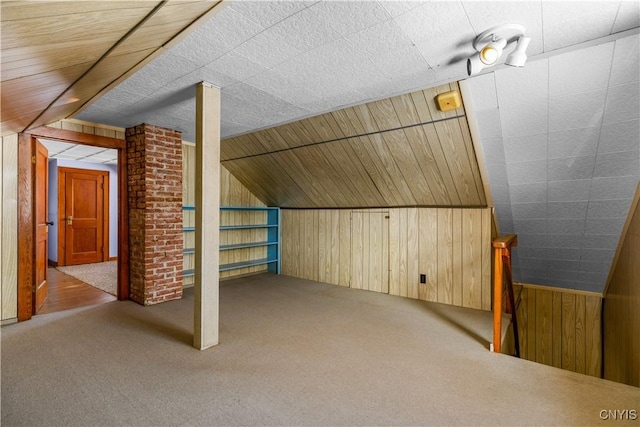 1407 Downer Ave, Utica, NY 13502 - additional living space featuring wood walls, carpet floors, and vaulted ceiling