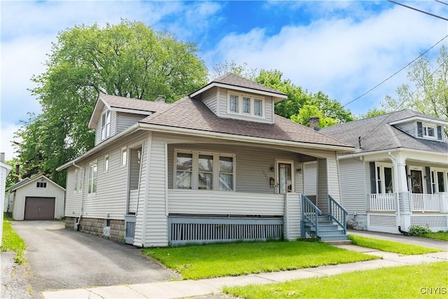 1407 Downer Ave, Utica, NY 13502 - view of front of home with covered porch, an outdoor structure, a garage, a shingled roof, and a front yard