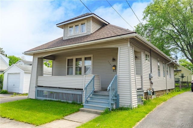 1407 Downer Ave, Utica, NY 13502 - view of front of property with a porch, an outbuilding, a detached garage, and a shingled roof