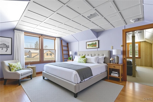 1407 Downer Ave, Utica, NY 13502 - bedroom with wood finished floors, lofted ceiling, and wooden walls