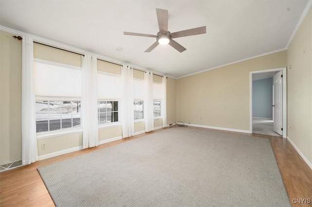 empty room featuring ornamental molding, light hardwood / wood-style floors, and ceiling fan