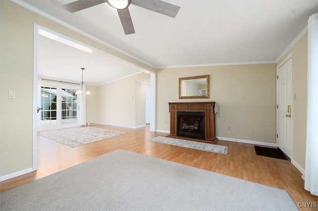 unfurnished living room with crown molding, light hardwood / wood-style flooring, and ceiling fan with notable chandelier