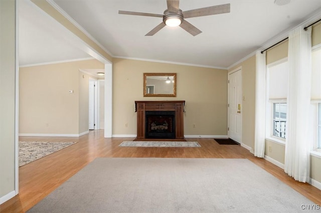 unfurnished living room featuring crown molding, ceiling fan, and light wood-type flooring