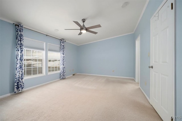 carpeted empty room with ornamental molding and ceiling fan