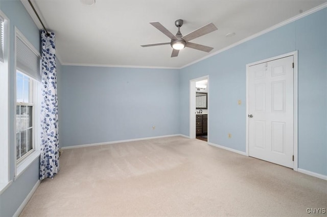 carpeted empty room with ornamental molding and ceiling fan