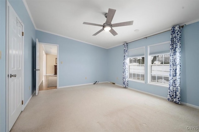 unfurnished bedroom with crown molding, light colored carpet, and ceiling fan