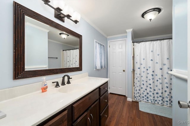 bathroom featuring vanity, wood-type flooring, ornamental molding, and walk in shower