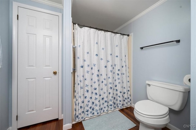 bathroom featuring crown molding, wood-type flooring, toilet, and a shower with curtain