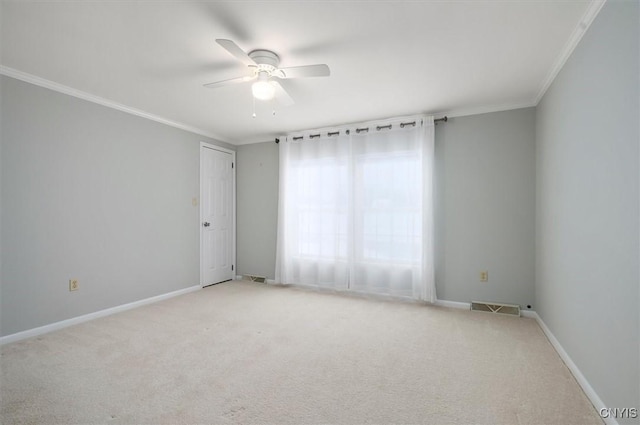 carpeted empty room featuring crown molding and ceiling fan