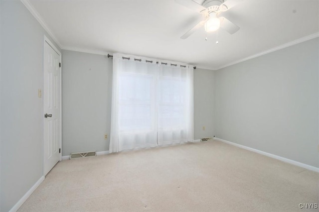 carpeted empty room with crown molding and ceiling fan