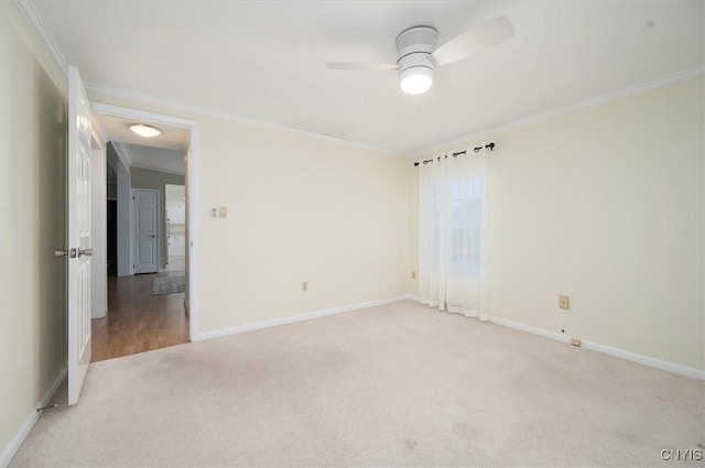 empty room featuring crown molding, ceiling fan, and light carpet