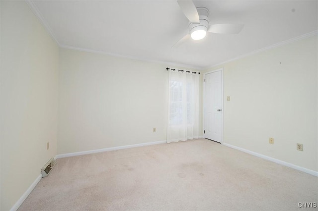 empty room featuring crown molding, light colored carpet, and ceiling fan