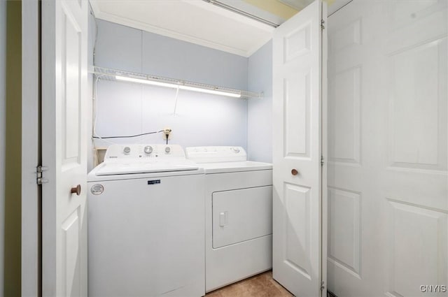 laundry area with crown molding and washer and dryer