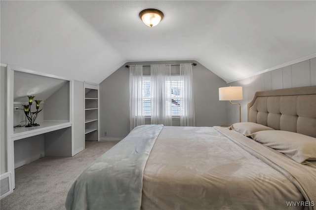 bedroom with light carpet and vaulted ceiling