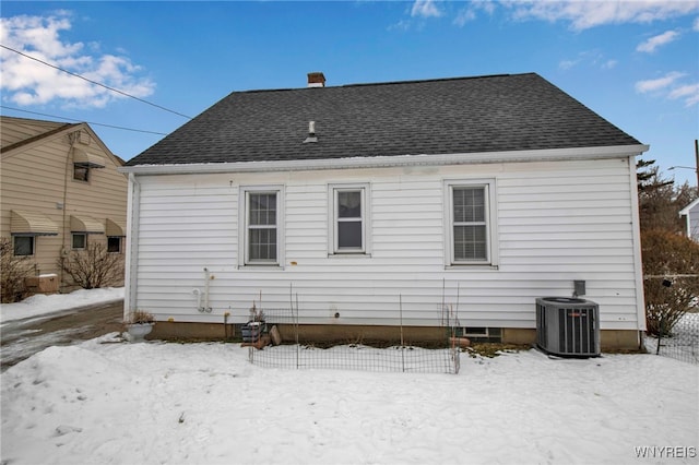 snow covered property featuring central AC