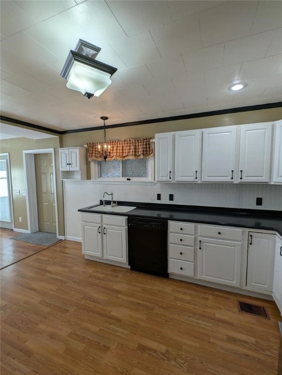 kitchen featuring pendant lighting, sink, white cabinets, and dishwasher