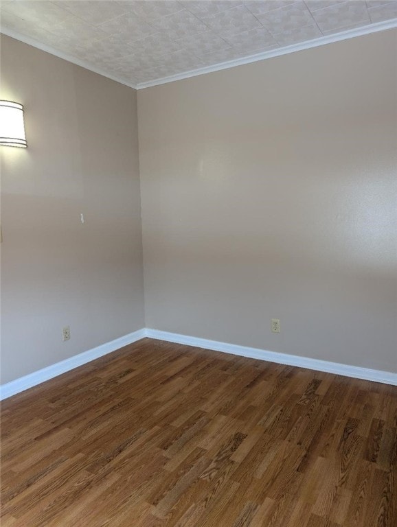 unfurnished room with crown molding and hardwood / wood-style floors