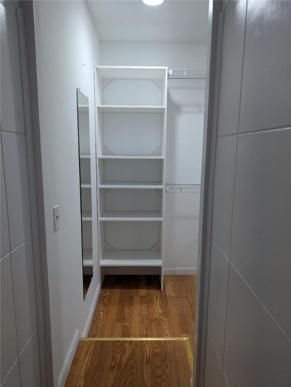 spacious closet featuring hardwood / wood-style flooring