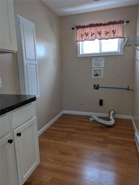 laundry room featuring cabinets, hookup for a washing machine, and dark hardwood / wood-style floors