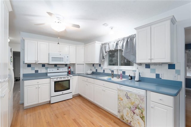 kitchen featuring white appliances, light hardwood / wood-style floors, sink, and white cabinets