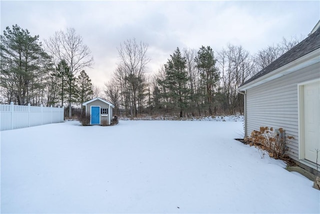 snowy yard with a storage unit