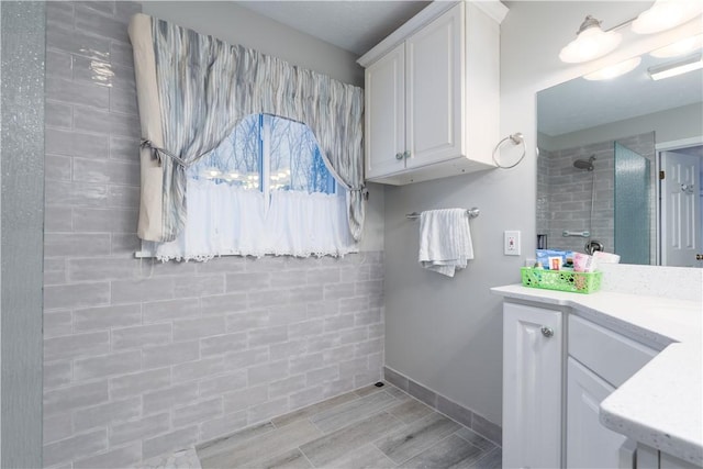 bathroom featuring vanity and a shower with shower door