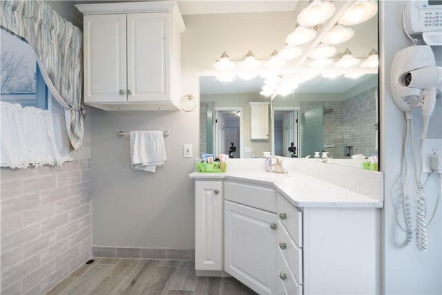 bathroom featuring vanity and tiled shower