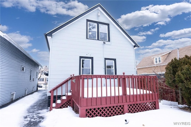 snow covered property featuring a deck