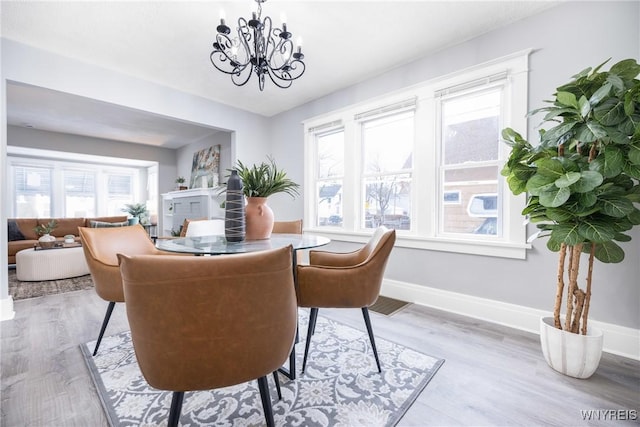 dining room featuring an inviting chandelier and light hardwood / wood-style floors