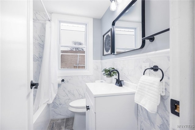 full bathroom featuring vanity, tile walls, shower / tub combo, and toilet