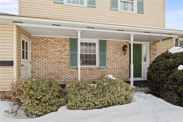 view of snow covered property entrance