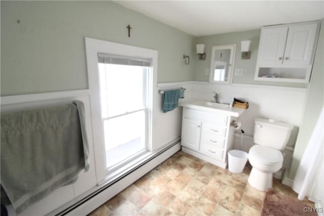 bathroom featuring baseboard heating, vanity, and toilet