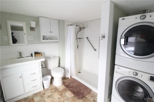 laundry area with stacked washer / drying machine and sink