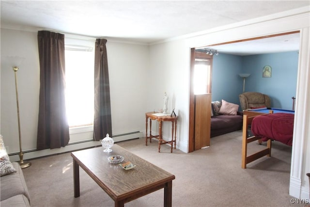 living room featuring baseboard heating, light colored carpet, plenty of natural light, and crown molding